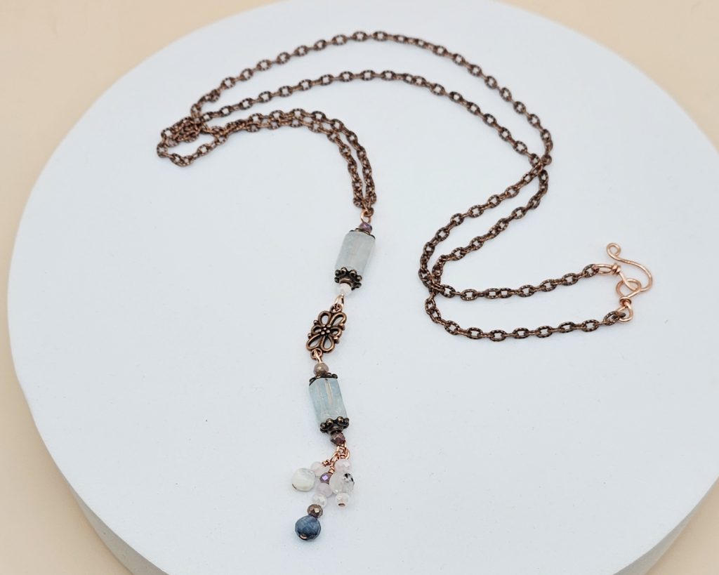 Necklace that is 26 Inches plus 3 Inch long drop, featuring
Aquamarine barrel beads
Copper accents and chain
Handmade Hook Clasp